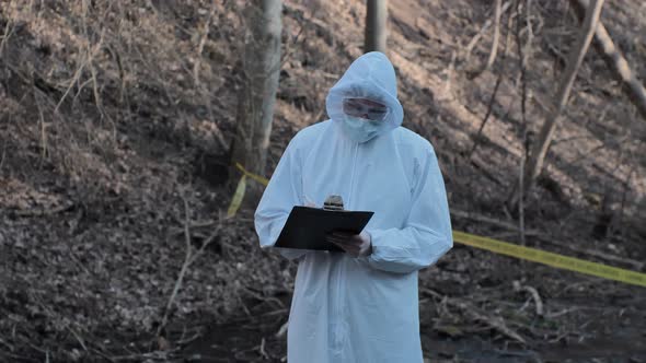 Forensic specialists working in the forest. Crime scene and police concept.