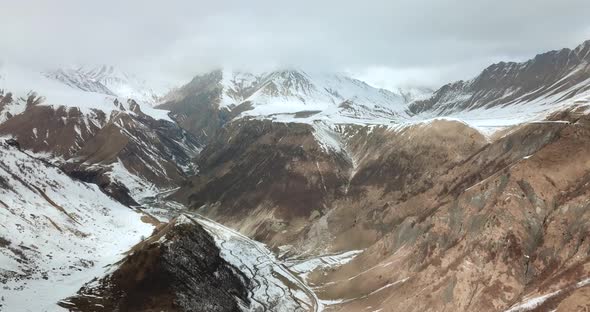 overhead flight shot goes on the snowy mountains landscape