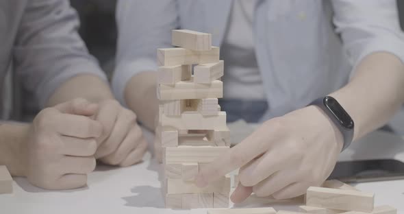 Unrecognizable Man Losing in Jenga