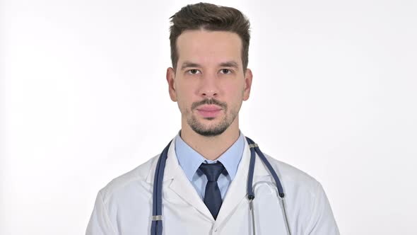 Portrait of Young Male Doctor Looking at the Camera, White Background