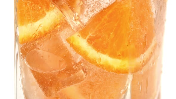 Adding Refreshment Cold Cocktail Transparent Glass Organic Orange Slice Ice Cubes Slow Motion Macro