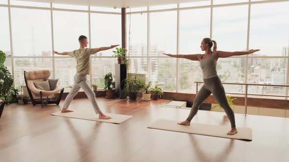 Pair Stretching At Yoga Studio