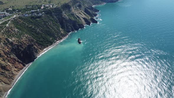 Aerial View From Above on Calm Azure Sea and Volcanic Rocky Shores