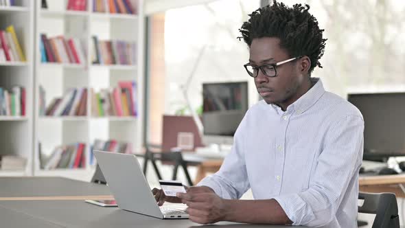 Online Payment Success on Laptop By African Man