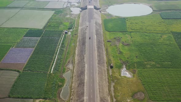 Aerial view of a road among the fields in Sapahar, Rajshahi, Bangladesh.