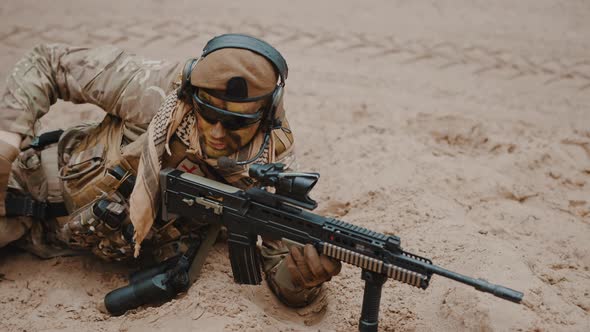 Marine Soldier Reaching Out for a Handgun Pistol at Ground Level Stance Aiming Using Target Scoop