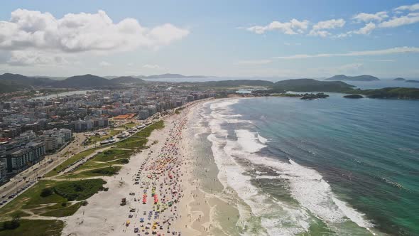 Aerial view, Beautiful beach crowded with tourist next to city buildings in Rio de Janeiro, Brazil