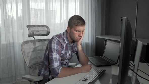 Handsome Man Falling Asleep in Front of His Computer