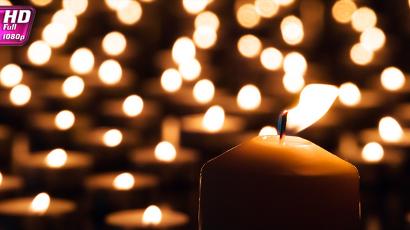 Large Candle On The Background Of Small alt