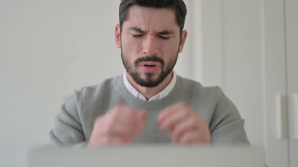 Close Up of Man Having Headache While Using Laptop