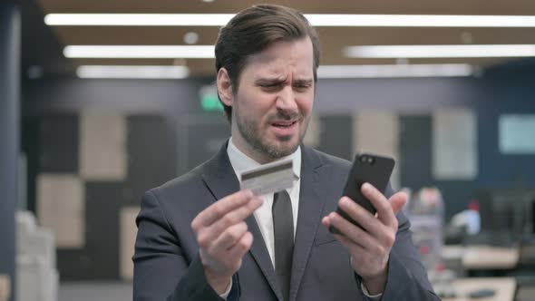 Portrait of Businessman Unable to Make Online Payment on Smartphone