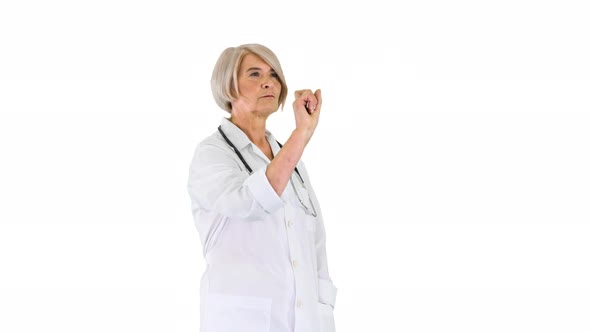 Elder Female Doctor Pressing a Buttons on Imaginary Futuristic Screen on White Background