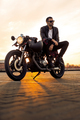 Brutal man sit on cafe racer custom motorbike. - PhotoDune Item for Sale