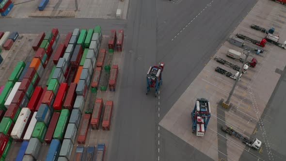 Aerial Overhead View Following a Forklift Operating in Cargo Container Terminal in Hamburg Germany
