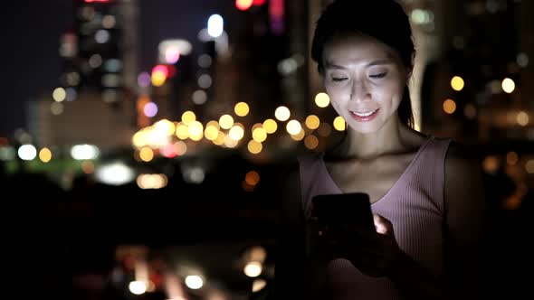 Woman looking at mobile phone in Hong Kong 