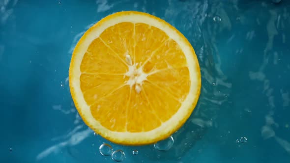 Orange Fruit Falling in Fresh Water