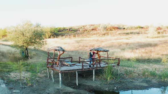 Inlove Couple Spending a Romantic Evening on a Pontoon in a Rural Area