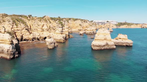Fly through Rocky Idyllic Lagos Ocean Coast in Algarve, Portugal - Aerial shot
