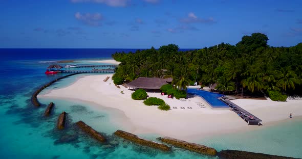 Wide birds eye island view of a white sand paradise beach and aqua blue ocean background in best quality