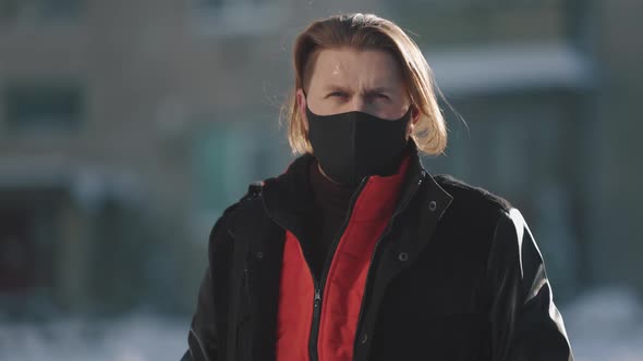 Man in Mask Standing Outdoors During Winter Weather