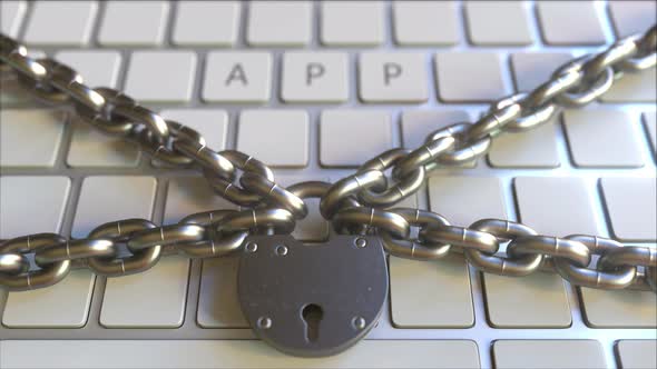 APP Text on the Keys of a Keyboard with Padlock and Chains alt