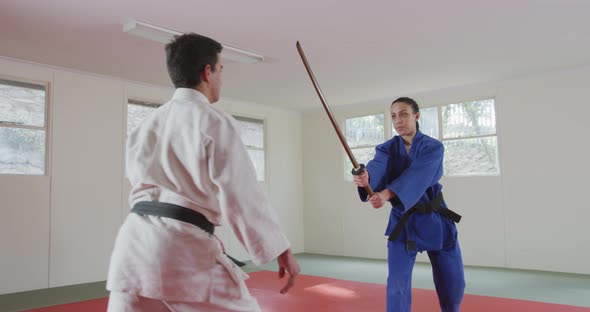 Judokas training with a wooden saber