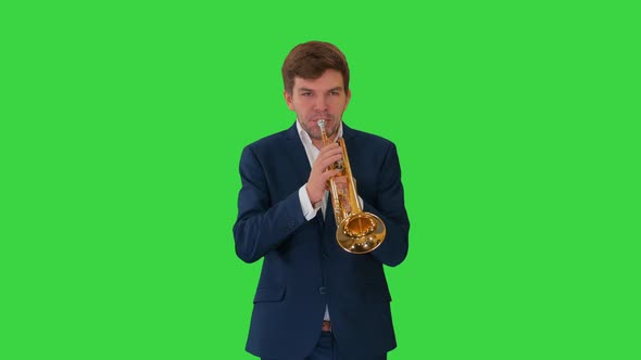 Young Man in Suit Playing a Trumpet While Walking on a Green Screen, Chroma Key