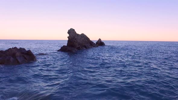 Aerial View over Cliff and Sea at Sunset