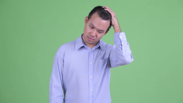 Stressed Asian Businessman Having Headache