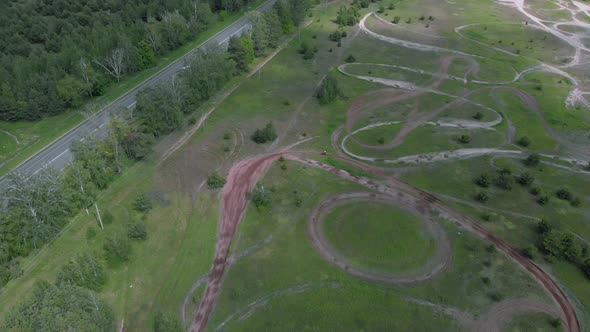 Aerial view of motorcycle race track with motorbike training for race track on a dirt cross circuit