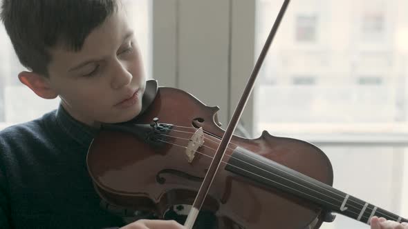 Boy playing violin during lesson