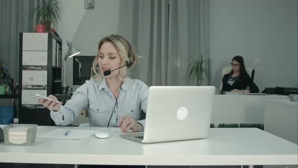 Two Smiling Women Working in Call Centre Answering Phone Calls