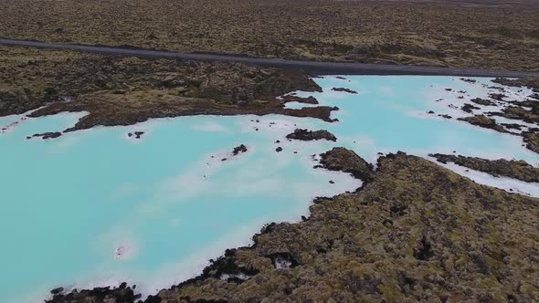 Drone shot of Blue Lagoon geothermal spa located on lava field in Iceland