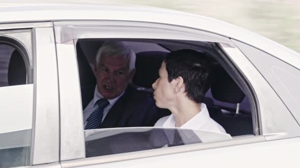 Businesspeople Chatting in Moving Car