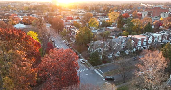 Cinematic colorful aerial establishing shot of homes in American suburb during sunrise. Dramatic lig