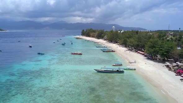 Local fishing boats.Fantastic aerial view flight pedestal down drone footageof Gili Trawangan drea