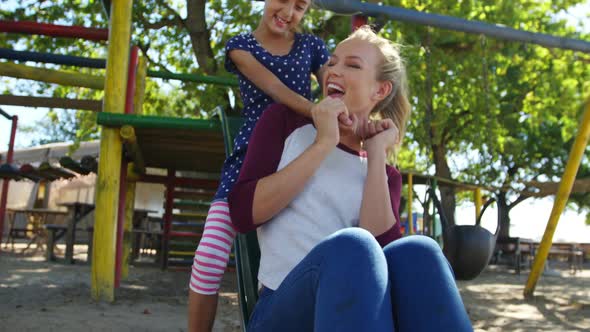 Mother and daughter playing in the playground 4k