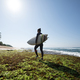Surfer with surfboard on seaside