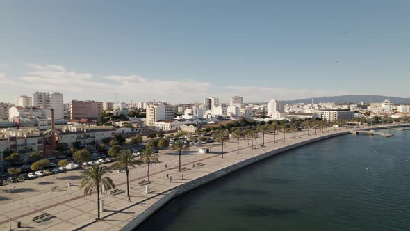 Aerial descending panoramic view over Portimão Beautiful Maritime sidewalk - Algarve