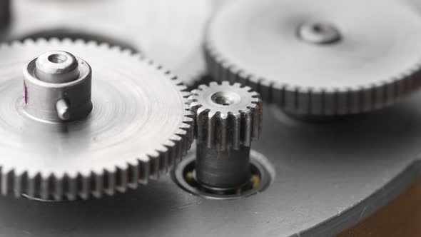 Gears rotating in a mechanical device. Machine metal gears rotating abstract