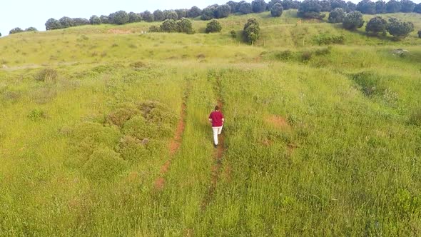 Aerial Alone Man in Green Fields