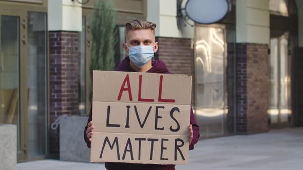 ALL LIVES MATTER Concept, No Racism. Outdoors Portrait of a Young Male Activist Wearing a Medical