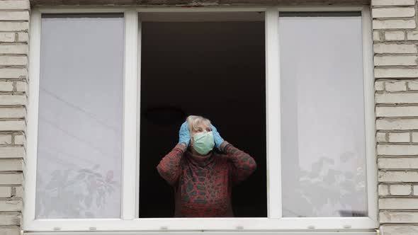 Old Woman Grandmother Stay at Window Isolated at Home on Quarantine. Coronavirus