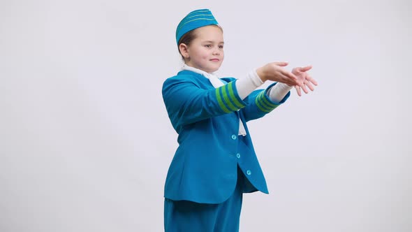 Pretty Confident Girl Air Hostess Gesturing Emergency Exits Smiling and Crossing Hands