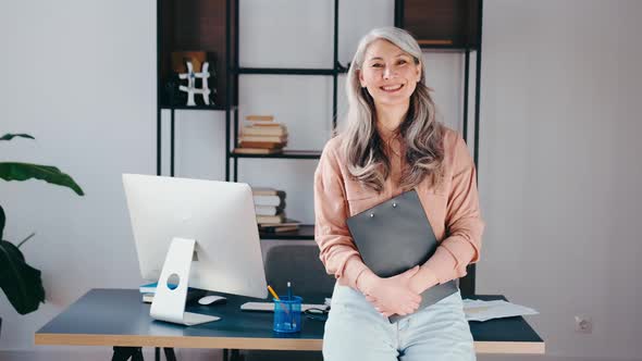 Confident Stylish Mature Gray Long Hair Asian Businesswoman Portrait with Office Background