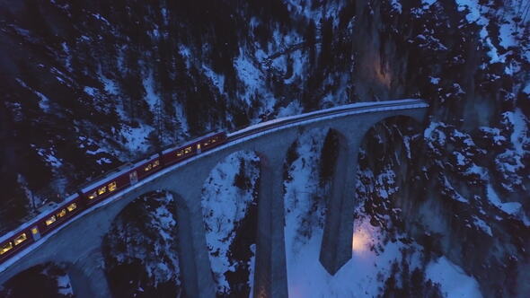 Landwasser Viaduct with Railway and Train at Winter Evening