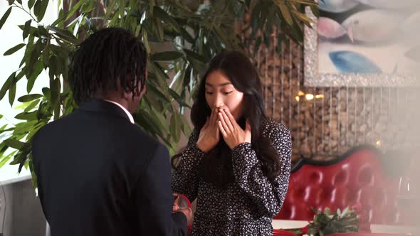 African Man Making Surprise for His Girlfriend on Valentine's Day at Restaurant