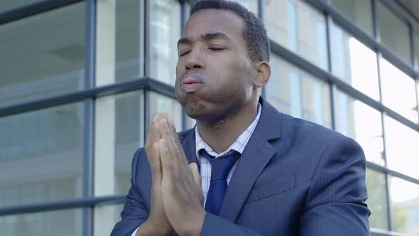 young thoughtful black african business man sighing worried 