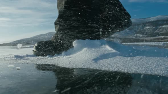 A Man Walks on Snowy Ice