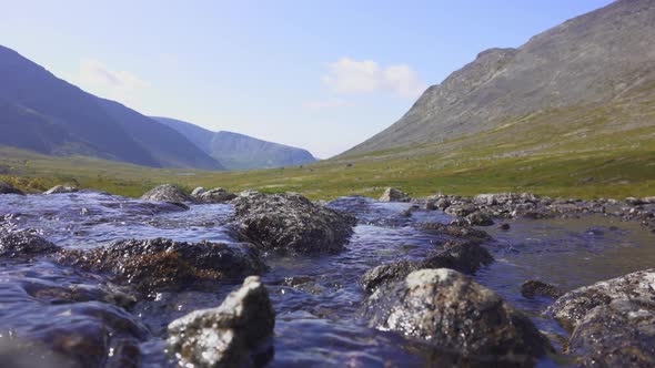 A Stormy Stream of River Carving Its Way Through the Mountain Valley